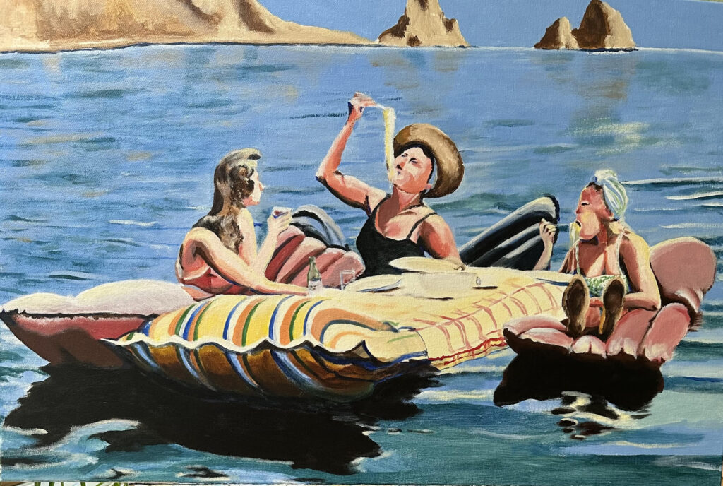 Three women lounging on inflatable rafts at sea
