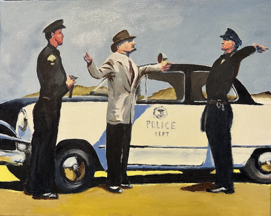 Man searched by two officers beside police car